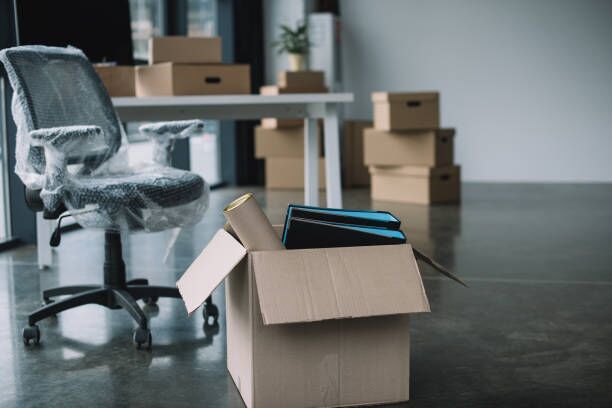 cardboard box with folders and office supplies in floor during relocation cardboard box with folders and office supplies in floor during relocation moving company stock pictures, royalty-free photos & images