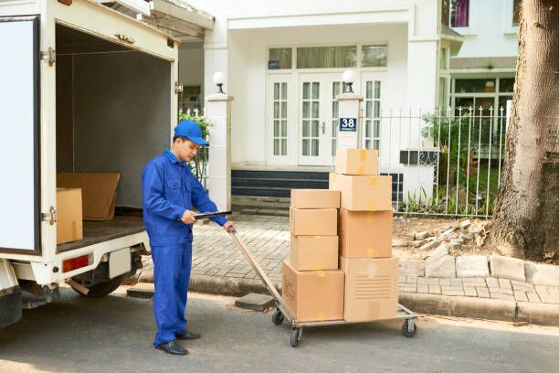 Delivery service worker loading truck Delivery service worker loading his truck with cardboard boxes moving company stock pictures, royalty-free photos & images