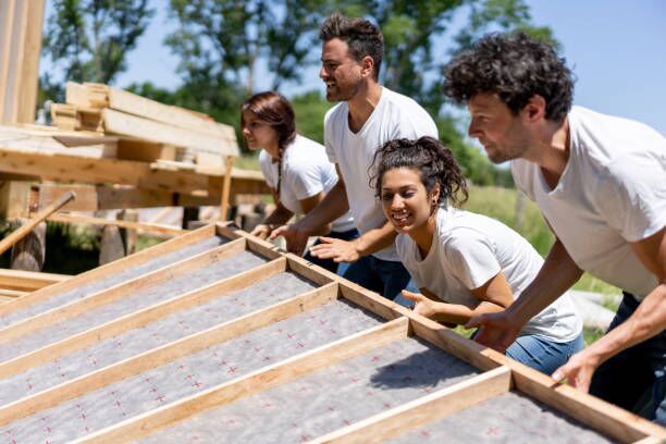 Latin american volunteers working hard at a charity construction project Latin american volunteers working hard at a charity construction project - Charity and relief concepts community development stock pictures, royalty-free photos & images