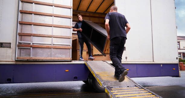 Loading removal truck Removal company helping a family move out of their old home moving truck stock pictures, royalty-free photos & images