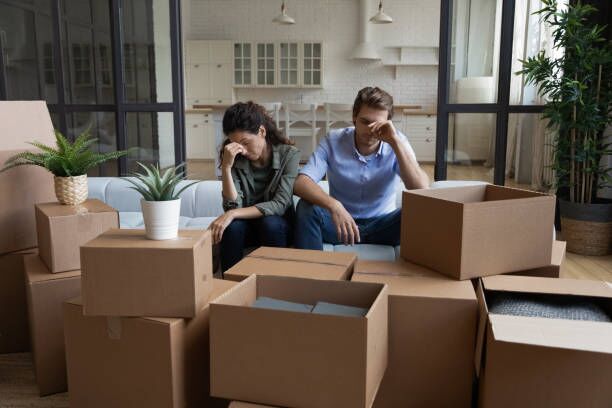 Unhappy couple have problems on moving day Tired unhappy young Caucasian couple sit on sofa in new living room feel unmotivated unpacking. Upset stressed millennial man and woman have fight quarrel unboxing packages relocating moving. relocation stock pictures, royalty-free photos & images