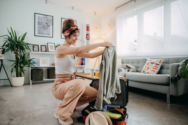 Always prepared Young woman preparing for road trip, packing suitcase Apartment packing stock pictures, royalty-free photos & images