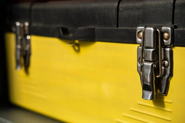 Yellow-black toolbox is closed with two metal locks. Yellow-black toolbox is closed with two metal locks. Close-up. gun safe movers stock pictures, royalty-free photos & images