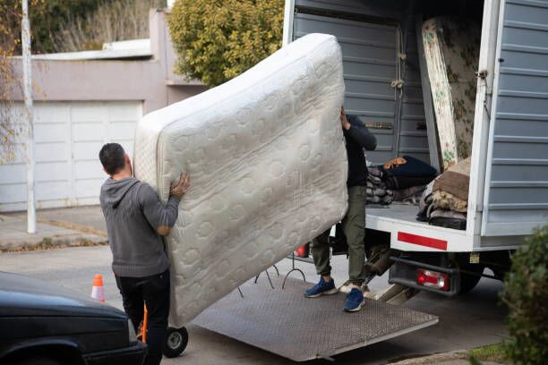 House moving process. Owner and moving staff packing, protecting and transporting furniture and movables to moving truck House moving process. Packaging and transportation to moving truck moving truck stock pictures, royalty-free photos & images