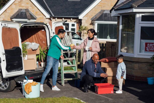 Family Taking a Break A shot of a mature grandfather wearing casual clothing taking a break from unloading boxes and furniture from the rear of a moving van with his wife, son and young grandson, they are drinking hot drinks. moving truck stock pictures, royalty-free photos & images