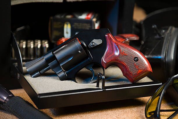 Handgun and Safe A revolver handgun with a gun safe and shooting equipment. gun safe stock pictures, royalty-free photos & images