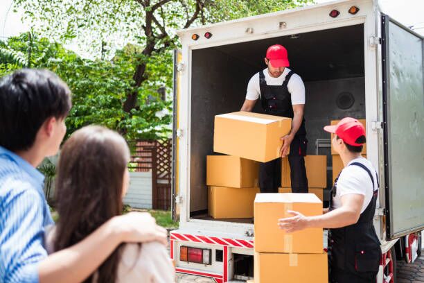 Asian and Caucasian workers in uniform unloading cardboard boxes from the truck. Delivery men unloading boxes and check the checklist with their coworkers. Professional delivery and moving service. Asian and Caucasian workers in uniform unloading cardboard boxes from the truck. Delivery men unloading boxes and check the checklist with their coworkers. Professional delivery and moving service. moving company stock pictures, royalty-free photos & images