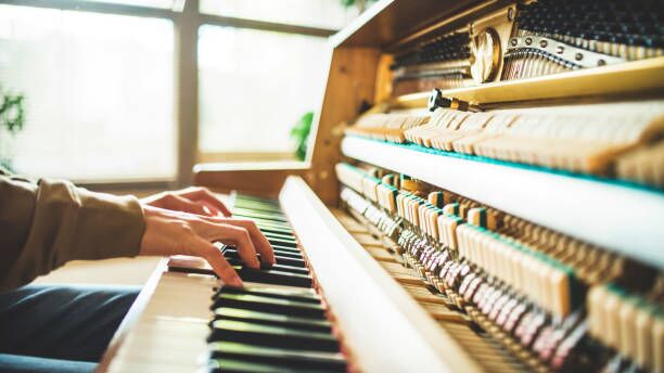 Close-up human hands practicing piano lessons and playing classical music on an old piano Man practicing on the piano. Learning a new instrument. Fingers pressing black and white piano keys piano keys stock pictures, royalty-free photos & images