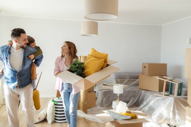 Cheerful family moving in new home Happy Caucasian family with one little boy starting new life in new apartment movers carrying boxes stock pictures, royalty-free photos & images