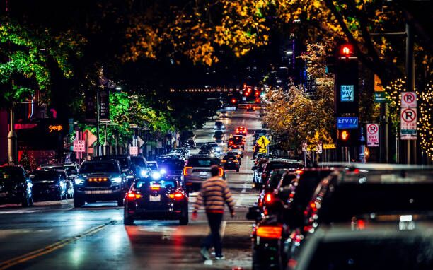 Downtown by night - Dallas, Texas Dallas, Texas, USA - Man walking through night traffic in downtown district. Dallas moving stock pictures, royalty-free photos & images