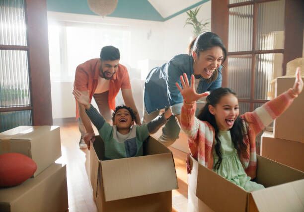 Happy family, parents and children in boxes in new home or playing game, property investment and real estate. Excited, people and moving day with fresh start and celebration for bond payment on house Happy family, parents and children in boxes in new home or playing game, property investment and real estate. Excited, people and moving day with fresh start and celebration for bond payment on house moving stock pictures, royalty-free photos & images
