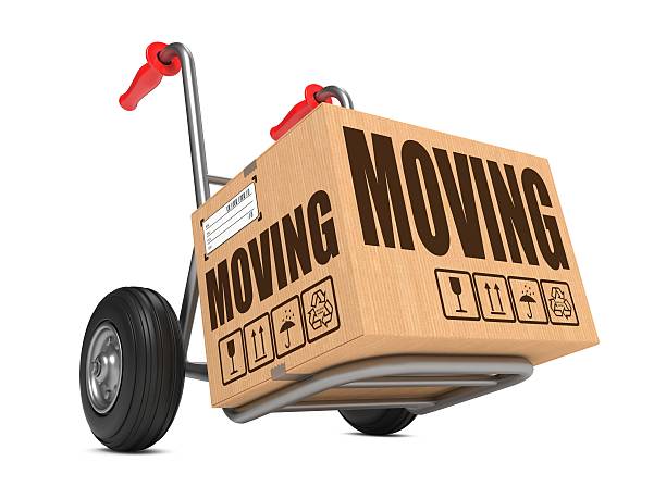 Moving - Cardboard Box on Hand Truck. Moving - Slogan on Cardboard Box on Hand Truck White Background. moving company stock pictures, royalty-free photos & images