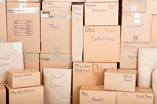Moving boxes Wall with boses labled and ready fpr shiping labelling boxes stock pictures, royalty-free photos & images