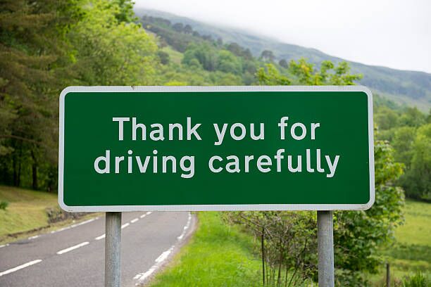 Thank you for driving carefully sign Sign beside a two-lane highway that reads "Thank you for driving carefully" road safety stock pictures, royalty-free photos & images