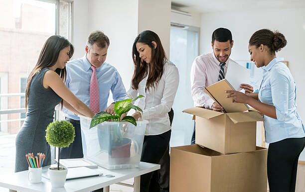 Business people moving and packing in boxes Group of business people moving to a new office and packing in boxes moving company stock pictures, royalty-free photos & images
