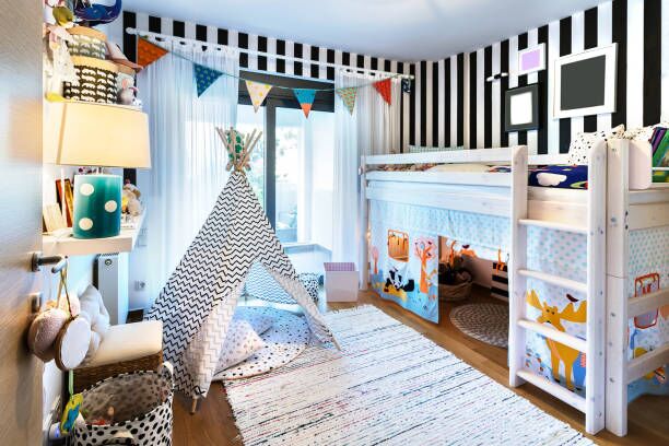 Kid bedroom with teepee and bunk bed. Kids bedroom with bunk wooden bed, teepee, stands, carpet frames and toys. kids rooms stock pictures, royalty-free photos & images