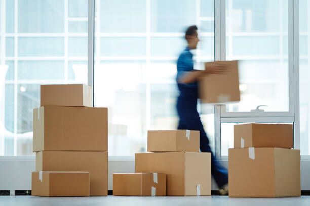 Packages with supplies Blurred motion of contemporary worker with packed box walking to new office while delivering it to client professional moving company stock pictures, royalty-free photos & images